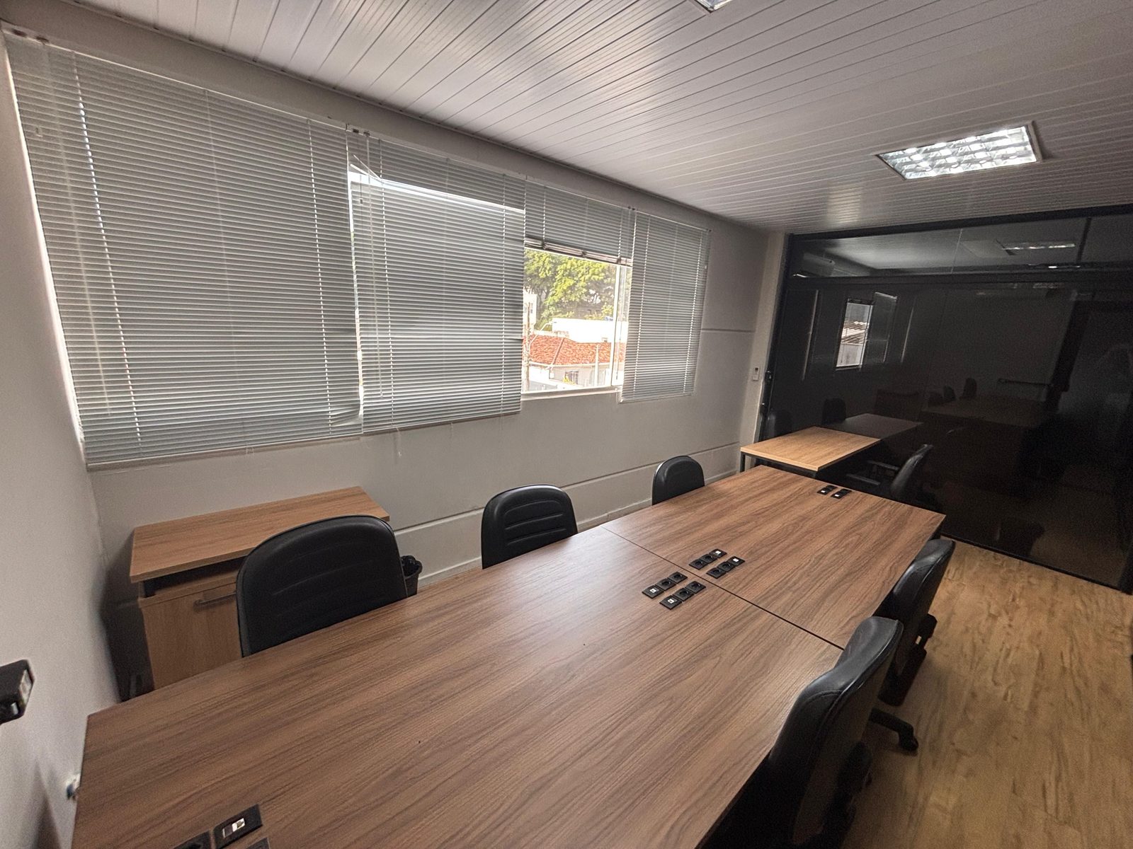 Sala de reunião da UP Working com mesa longa e cadeiras executivas